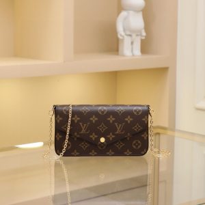 The Felicie handbag is an elegant and compact accessory featuring two detachable pockets, making it a stylish choice for carrying and organizing your daily essentials. More than just a wallet, it transforms into a charming clutch or small handbag when the gold chain is removed.- 1 flat inner pocket - Two detachable components: a zippered pocket with leather pull tab and a flat flap pouch with 8 credit card slots - Detachable shiny gold chain - Snap closure - Calfskin trim - Fabric lining - Shiny gold metal hardware Dimensions: 21*11*2 cm